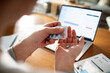 © Marko Geber - Close-up of a mans hands with medication and a laptop on a desk