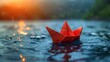 © Werckmeister - A boat made of colored paper in the water. Origami handicraft. Spring the river is melting.