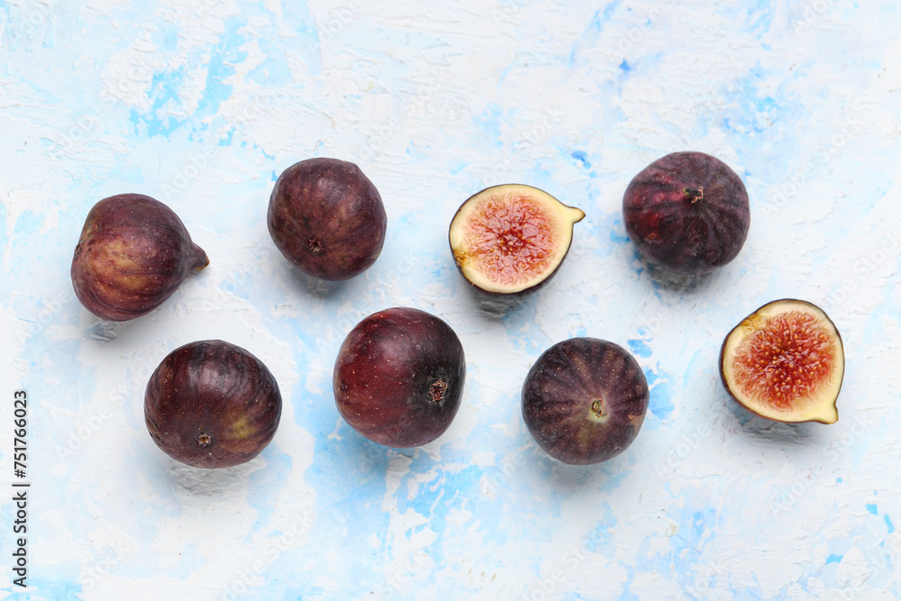 Fresh ripe figs on light blue background