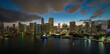 View from above of brightly illuminated high skyscraper buildings in downtown district of Miami Brickell in Florida, USA. American megapolis with business financial district at night