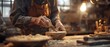 Artisan crafting with wood in traditional woodworking shop