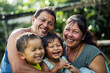 © InputUX - Candid shot of a Mexican family sharing laughter and joy, with the father, mother, and children basking in a moment of gratitude and the essence of a simple, happy life.