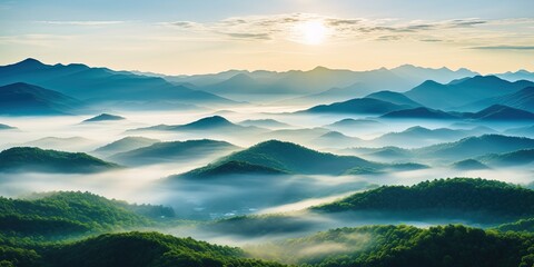 Wall Mural - Beautiful green mountain landscape with morning sunrise sky and fog. Aerial view of green trees in tropical mountain forests and fog in winter.