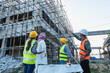 © Jack Tamrong - construction workers with Arab businessman looking at construction building on site