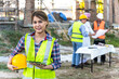 © Jack Tamrong - Young Asian home builder woman using tablet working in construction site with group of engineer and Arab man background