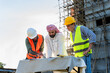 © Jack Tamrong - Arab developer businessman with Caucasian builder and architect man in construction site