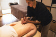 © ADDICTIVE STOCK - Therapist Giving Relaxing Shoulder Massage in Spa