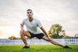 © Miljan Živković - one man male athlete stretch outdoor at stadium track