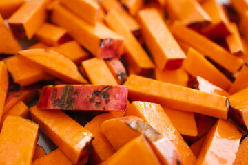 sweet potato fries hand cut into oven tray before roasting, simple ingredients concept