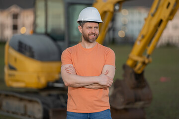 Wall Mural - Builder man at building site. Construction manager in helmet. Male construction engineer. Architect at a construction site. Handyman builder in hardhat. Building concept. Builder foreman.