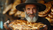 man in a hat with a giant pesach for passover day