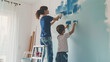 Mother and son painting the wall for home improvement in the living room