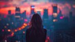 A woman stands on a high vantage point, looking out over a city brightly illuminated by night lights
