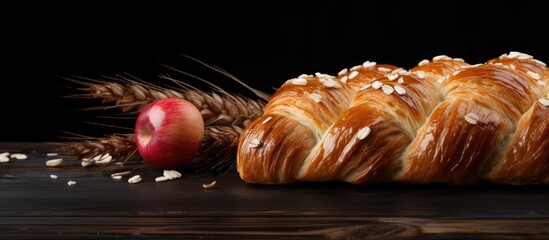 Leinwandbilder - Rustic Croissant Garnished with a Fresh Red Apple and Golden Wheat on Dark Wooden Background