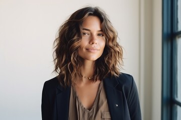 Wall Mural - Portrait of a beautiful young woman in a business suit looking at the camera