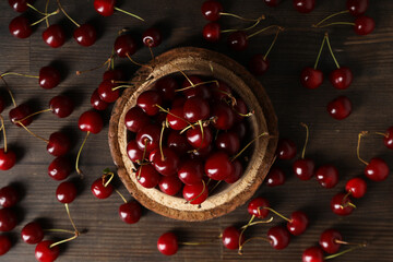 Sticker - Ripe cherry fruits in a bowl on a wooden background