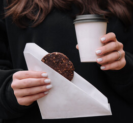 Wall Mural - Woman holding a mug of coffee and Oatmeal Cookies in her hands