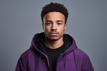 Wall Mural - Young african american man with afro hairstyle in a purple jacket.