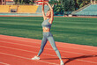 © Yevhen - Fit girl do outward lunging. Physical training education. Sports lesson. Female runner stretching before workout