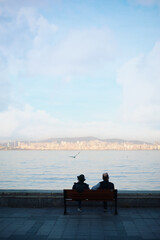 Wall Mural - Beautifil landscape with men sitting on the bench on the seashore, Istanbul Turkey