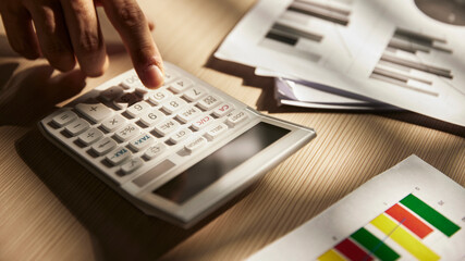 Desk with calculators for calculating, managing and
analyzing economic profits and losses.