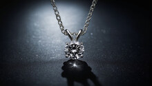 large diamond in a platinum necklace on a dark background.