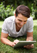 © Mikolette Moller/peopleimages.com - Man, tablet and backyard reading or relax connection or browsing social media on weekend, subscription or online. Male person, garden and nature rest for web entertainment, researching or internet