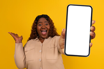 Emotional african american chubby woman showing phone