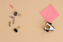 Office Supplies Top View With Pink Sticky Notepad And With Staple Remover.