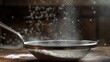 Image of sifting flour through a fine mesh sieve.