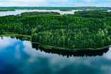 Fototapeta Na ścianę - Aerial view of blue lakes and green woods  sunny summer day in Finland from above