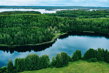 Wall Mural - Aerial view of blue lakes and green woods  sunny summer day in Finland from above