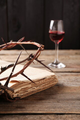 Wall Mural - Crown of thorns, Bible and glass with wine on wooden table, selective focus