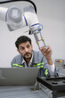 © Nassorn - Latino robotic development engineer working robot arm connection control at electronic futuristic science laboratory. Hispanic technician learning innovation machine in automated engineering academy.