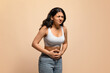 © Prostock-studio - Stomach Pain. Sick young indian woman suffering from acute abdominal ache