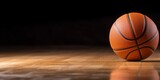 Fototapeta Sport - Basketball on Hardwood Court with Dark Background