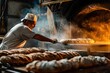 A baker pulling freshly baked bread out of the oven in the early morning