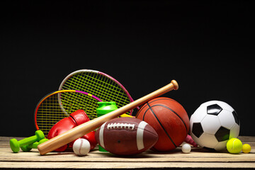 Wall Mural - Various sports equipment on black background studio shot