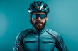 cyclist in sportswear with a helmet, isolated on a vibrant cyan background, representing speed and fitness