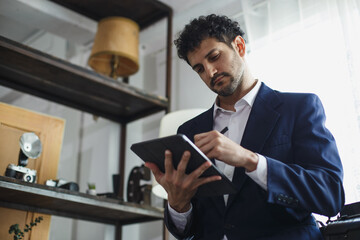 Poster - Successful businessman holding pointing typing digital tablet working at office. charming man Business man style.