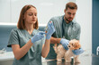 © standret - Medicine in the syringe. Cute little dog in veterinary clinic with two doctors