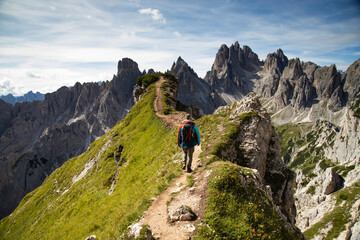 Sticker - Stunning view of a tourist on the top of a hill enjoying the view of the Cadini di Misurina