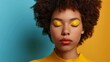 Enjoyed the African American Fashion Model portrait. A happy brunette with afro hair style and closed eyes shows off her lips and eyeshadows on a colorful background while wearing yellow make-up.