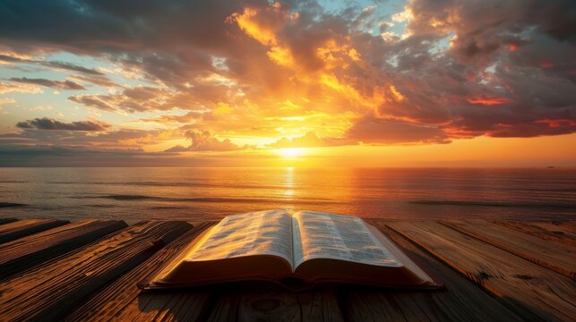 Sunset background with a silhouetted open Bible on a wooden table