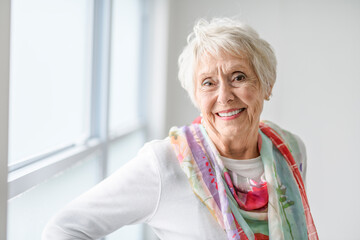 Wall Mural - senior lady posing at home portrait close to a window