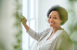 senior black American woman at home thermostat setting