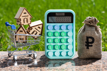 Wall Mural - Money bag with Russian ruble symbol, calculator and symbolic houses in a shopping cart