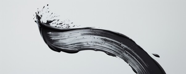 A bold black brush stroke on white, capturing gesture and monochrome art vibes