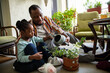 © Marko Geber - Father and daughter watering plants at home