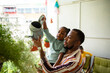 © Marko Geber - Father and daughter watering plants at home